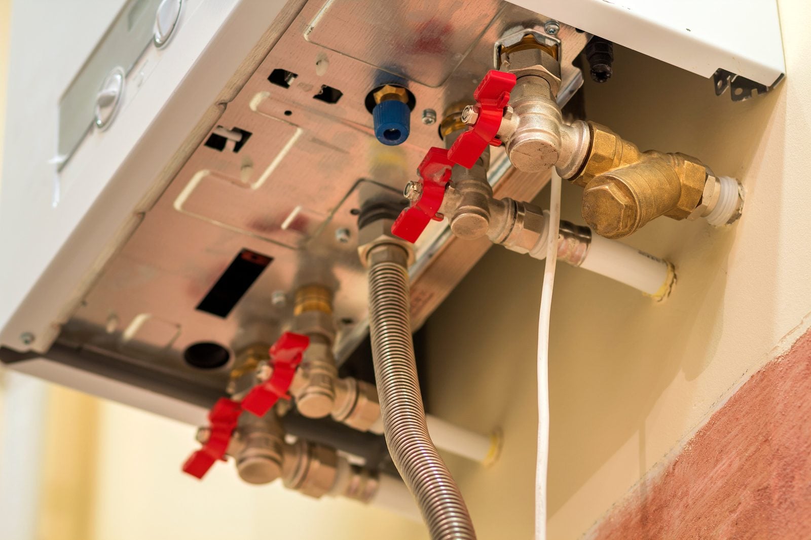 Gas water heater valves and pipes viewed from below